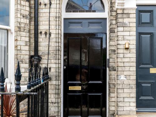 a black door on the side of a building at Priory Street in York