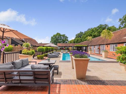 a courtyard with a swimming pool and a villa at The Pool House - Uk49372 in Send