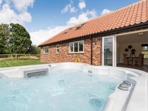 a hot tub in the backyard of a house at Kings Lodge in Neatishead