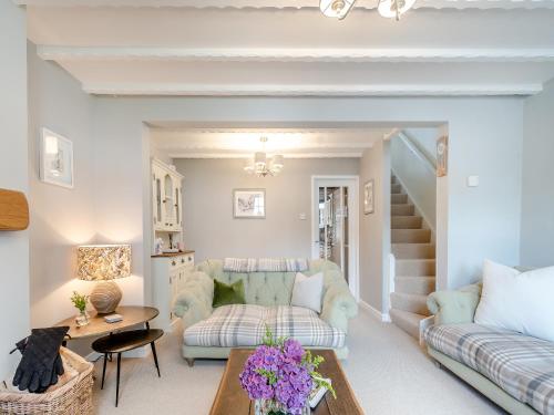 a living room with a couch and a table at Mrs Cracker's Cottage in Lund