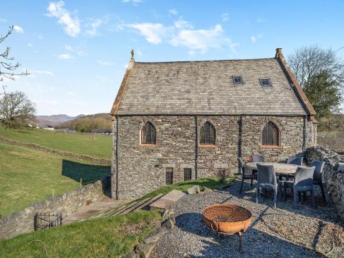 a stone building with a table and chairs in front of it at The Old Chapel in Ulverston