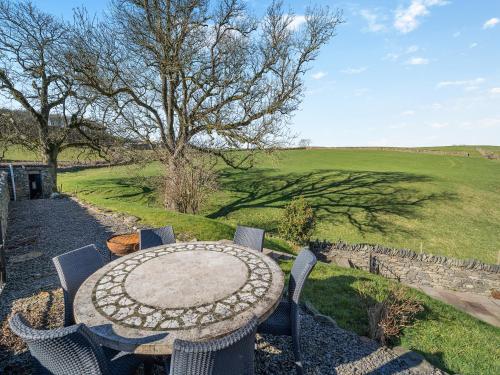 a table and chairs with a view of a field at The Old Chapel in Ulverston