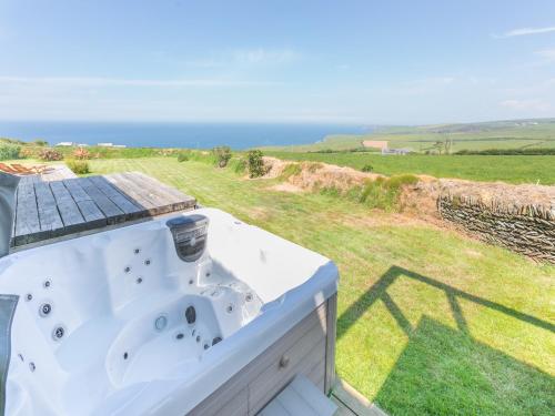 a bathroom with a sink and a view of the ocean at Lower Hendra Cottage in Port Isaac