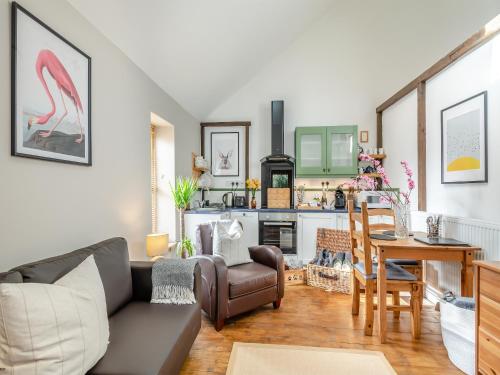 a living room with a couch and a table at The Dairy - Ukc3780 in Hickling