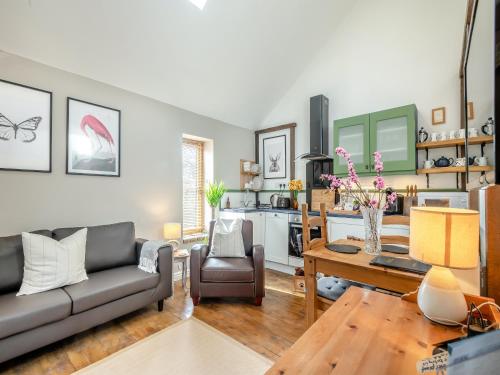 a living room with a couch and a table at The Dairy - Ukc3780 in Hickling