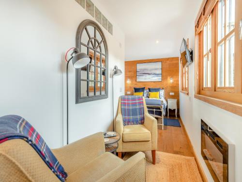 a living room with a couch and a chair at Copse Lodge in Eling