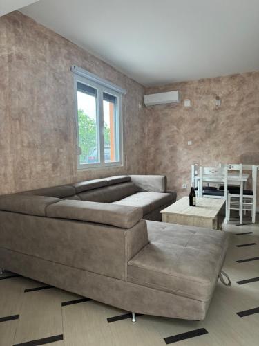 a living room with a large couch and a table at Green Oasis Budva in Prijevor
