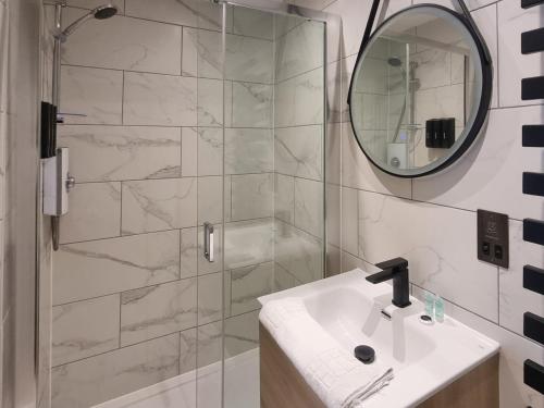 a bathroom with a shower and a sink and a mirror at Uk47853 - No 2B in Aberystwyth