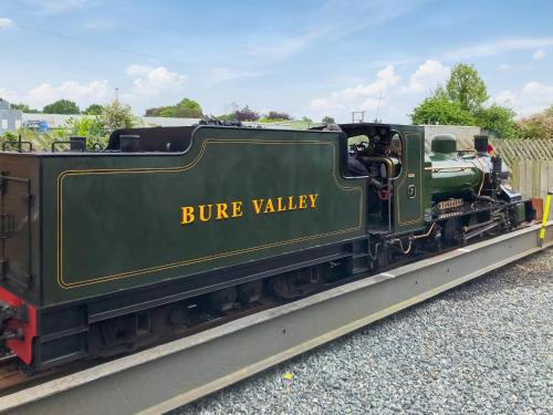 a green train is sitting on the tracks at The Dairy - Uk48866 in Aylsham