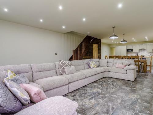 a living room with a couch and a dining room at The Millhouse - Uk32510 in Marloes