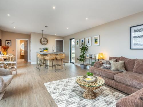 a living room with a couch and a table at Hayloft - Uk49529 in Buchlyvie