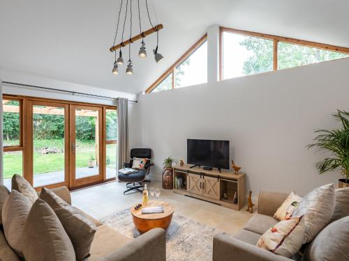 a living room with two couches and a television at North Farm Lodges in East Mersea