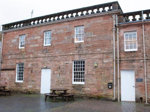 a brick building with a picnic table in front of it at Stableyard Studio - Uk7173 in Carronbridge