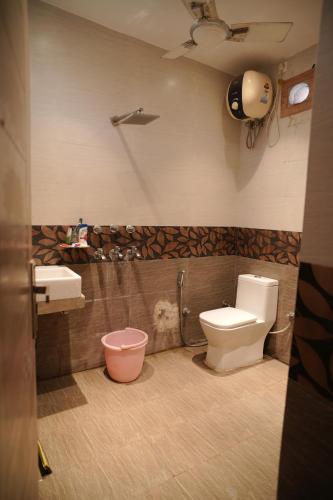 a bathroom with a toilet and a sink at royal palace and resort in Sultānpur