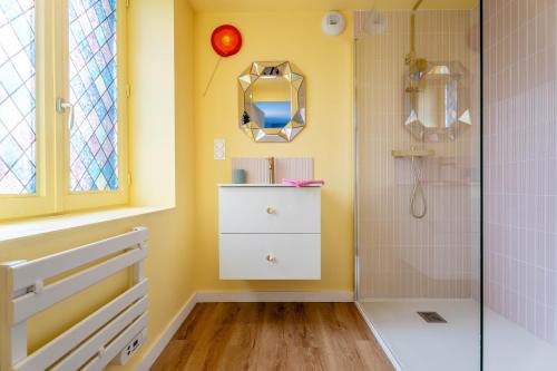 a bathroom with a white dresser and a shower at Le Candy by Clem in Pélussin