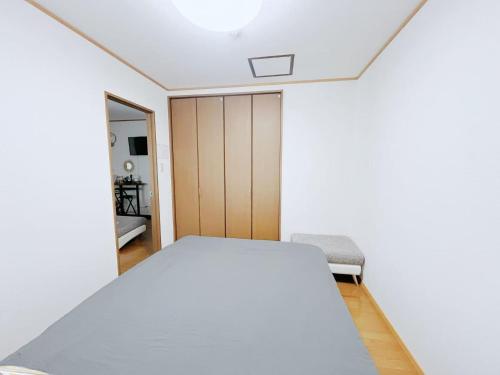 a bedroom with a bed and a mirror at LUMI HOUSE 101, 8 minutes to Namba 4 minutes walk to the station self check in in Osaka