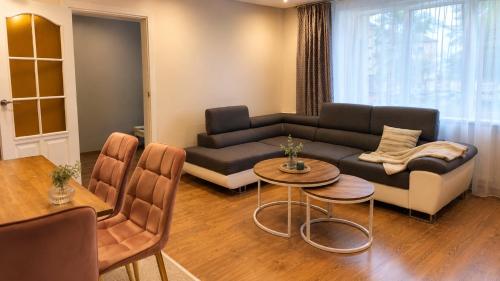 a living room with a couch and a table at Centro apartamentai in Zarasai