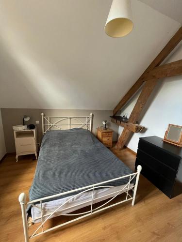 a bedroom with a metal bed in a attic at "la brise marine",wifi&parking in Quend