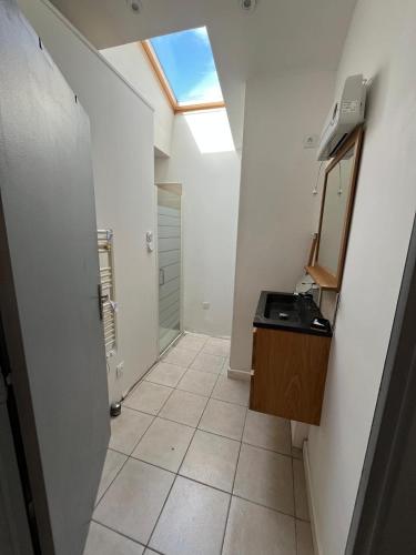 a bathroom with a vanity and a mirror and a sink at "la brise marine",wifi&parking in Quend