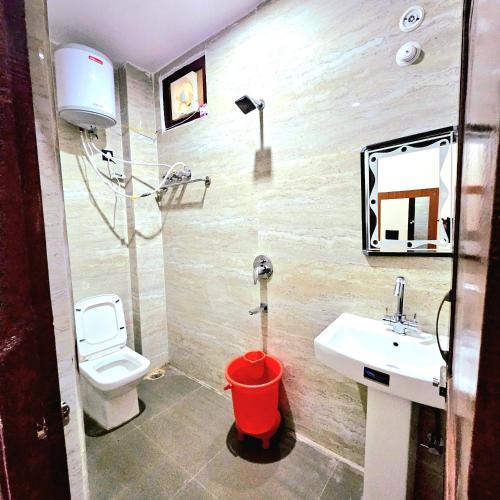 a bathroom with a toilet and a sink at Hotal DESPRADES MRITYUNJAY INN in Jageshwar