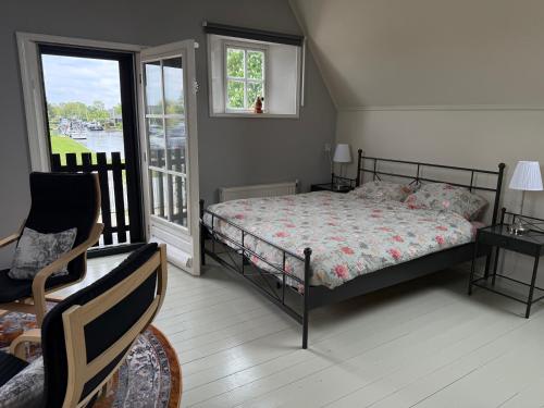 a bedroom with a bed and a balcony at het Binnenhuis in Workum
