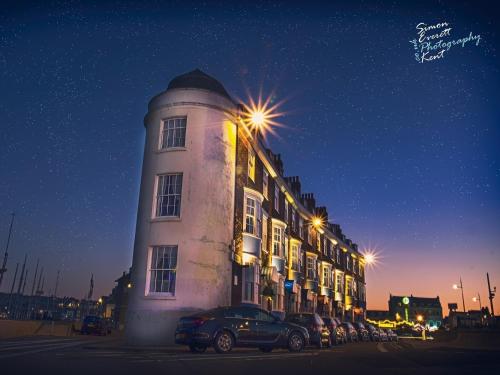 a white building with cars parked in front of it at The Roundhouse in Weymouth