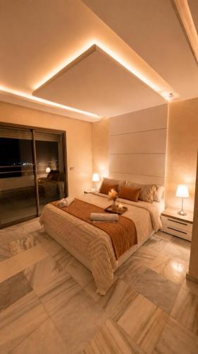 a bedroom with a large bed and a large window at The beautiful view in Tangier