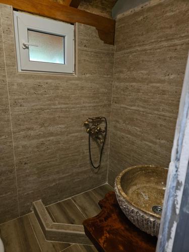 a bathroom with a sink and a window at Kucica in Lukavac