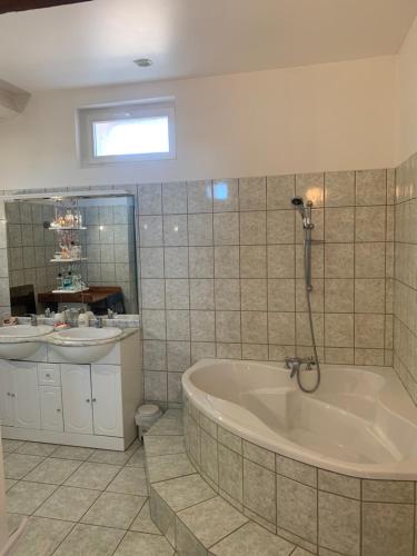 a bathroom with a tub and a sink at La Varenne in Changy