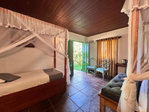 a bedroom with a bunk bed and a chair at The Cottage Sigiriya in Sigiriya