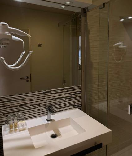 a bathroom with a sink and a large mirror at Aqua Ria Boutique Hotel in Faro