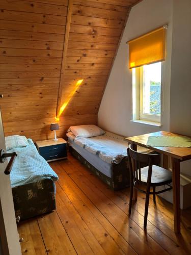 a bedroom with two beds and a table in a room at Agroturystyka Iwona Jażdżewska in Osława Dąbrowa