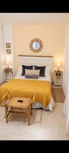 a bedroom with a large bed with a yellow blanket at Apartamento Belobodia in Cáceres