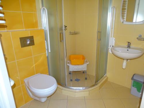 a bathroom with a shower and a toilet and a sink at Orwsnoch in Mielno