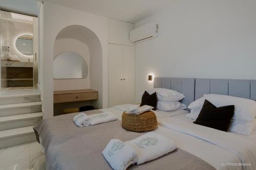 a bedroom with two beds with towels on them at Relaxury Villa II in Karpathos