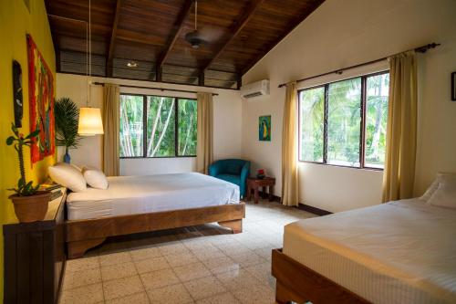 a bedroom with two beds and two windows at Tides Oceanfront Resort in Santa Cruz