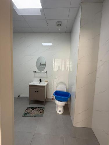a bathroom with a blue toilet and a sink at 3 room SUPERIOR APARTMENT at ELITE TOWER in downtown NURBIE'S TRAVEL in Ölgiy