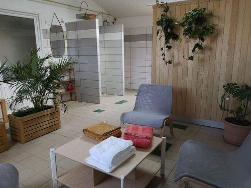 a room with two chairs and a table with towels at Camping Le Both d'Orouet in Saint-Jean-de-Monts
