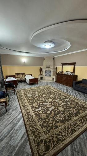 a large room with a large rug on the floor at Aruzhan Hostel in Shymkent