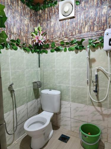 a bathroom with a toilet and a shower at CBR Beach in Kota Belud