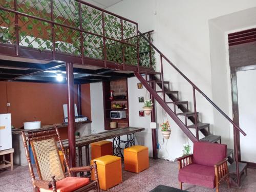 a living room with a staircase and chairs at "Casa de Piobeto" in Santa Ana