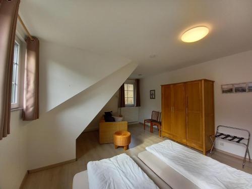 a bedroom with a bed and a stairway at Ferienhaus Buschmuehle - Stolpen in Stolpen