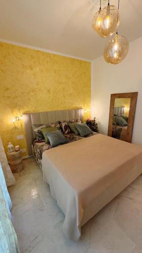 a bedroom with a large bed and a mirror at Dimora degli Ulivi in Bagnaia