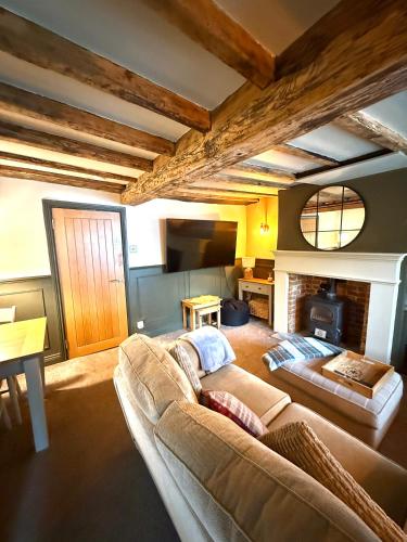 a living room with a couch and a fireplace at Rustic Retreat cottage in Thirsk