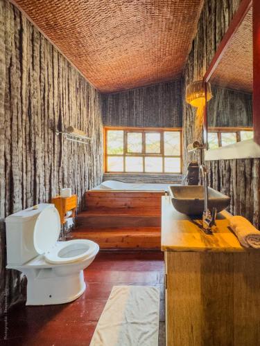 a bathroom with a toilet and a sink at Lodge Océan et Savane in Saint-Louis