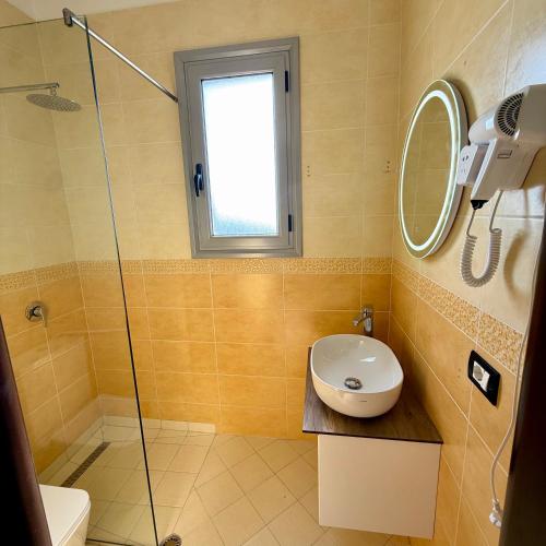 a bathroom with a sink and a shower at AL Hotel in Vlorë