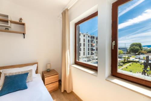 a bedroom with a bed and a large window at Stella Maris in Ploče