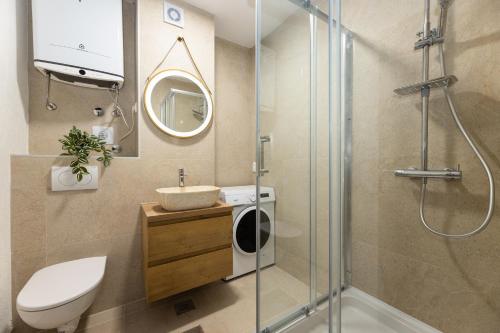 a bathroom with a shower and a toilet and a sink at Stella Maris in Ploče