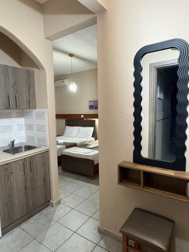 a living room with a mirror and a bed at Amelies Apartments in Paralia Katerinis
