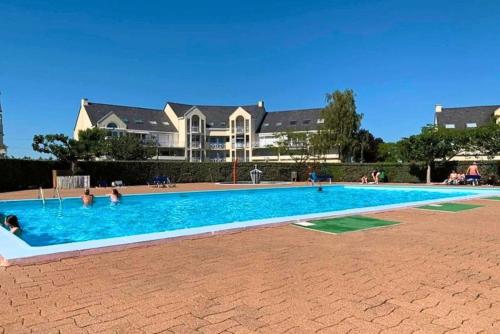 a large swimming pool in front of a house at Studio l'Oasis - Piscine, plage de La Baule 10 min in Guérande